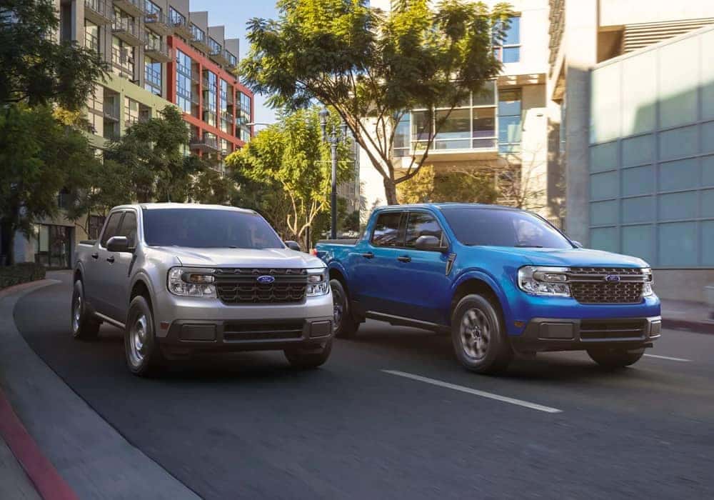 Two Ford trucks driving on the road