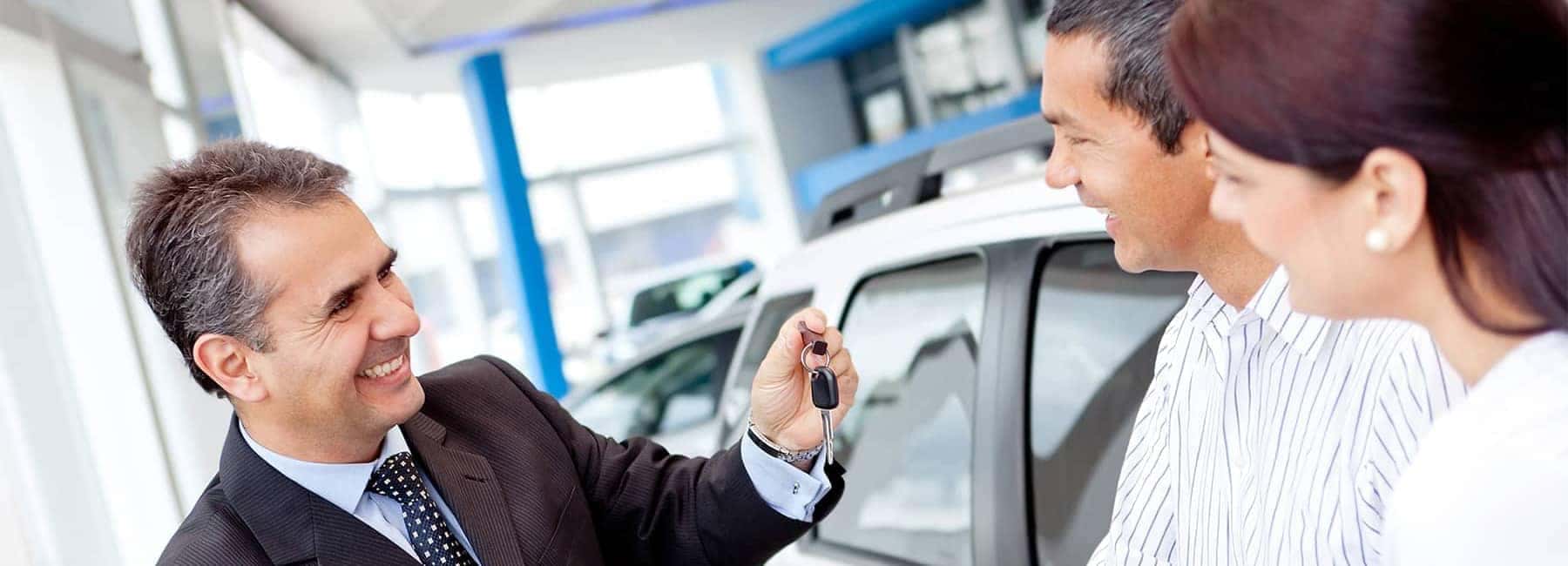 Salesman-Handing-Couple-Car-Keys