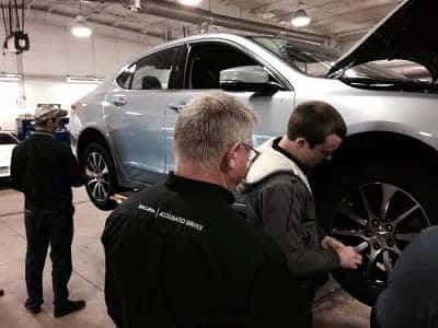 Acura of Orange Park Service Technicians working on tire