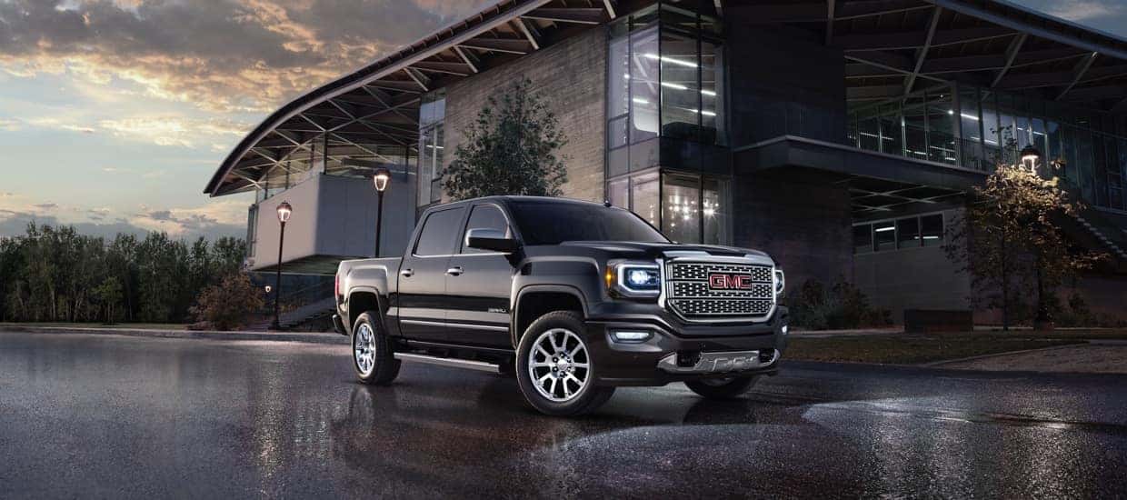 black GMC truck parked in front of modern building