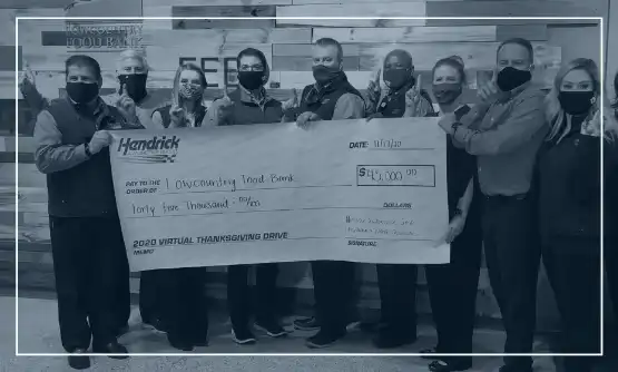 Hendrick employees holding donation check 