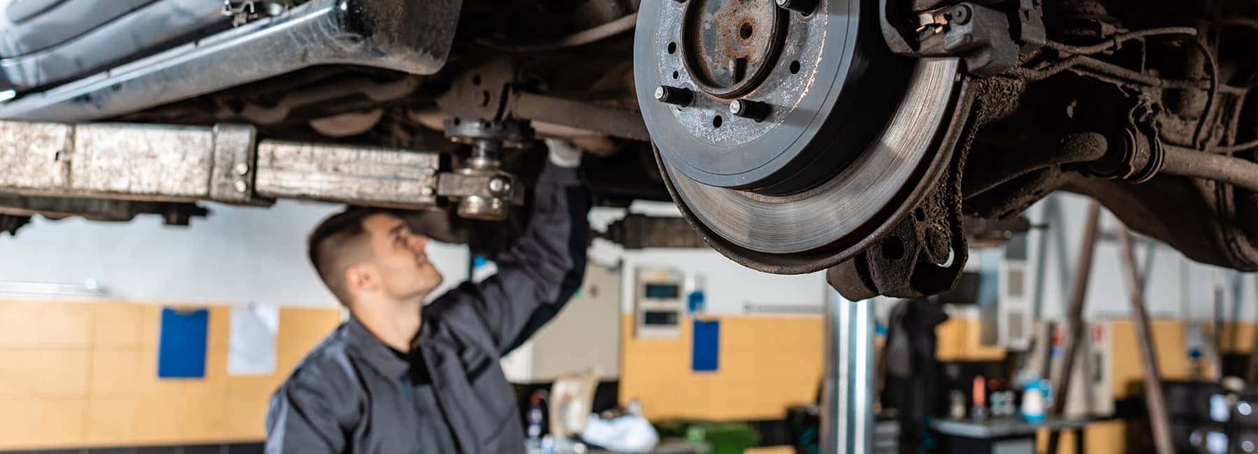 Mechanic working under an elevated car