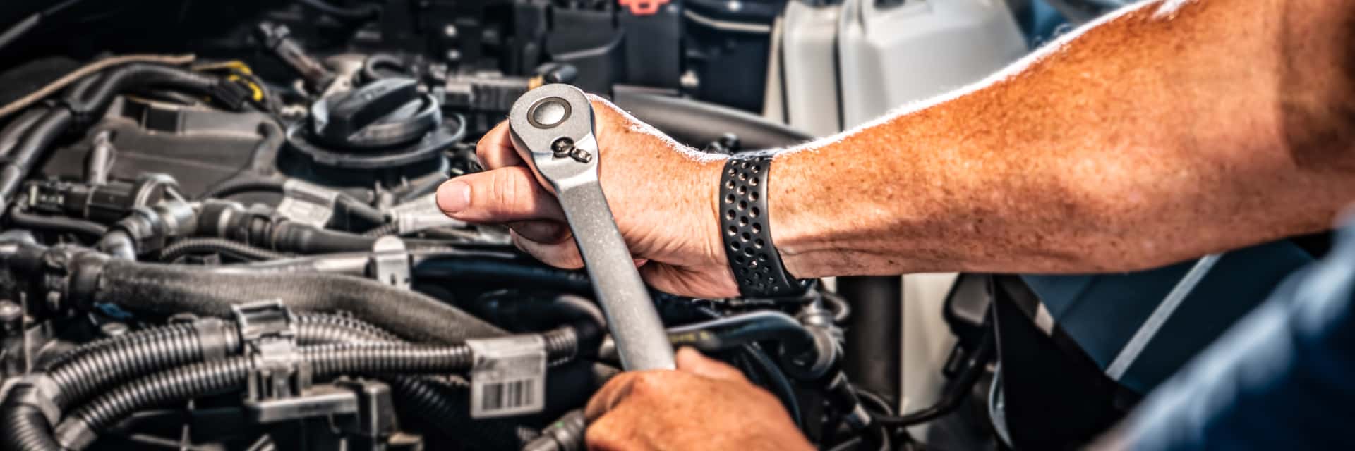 Service technician working on a vehicle engine
