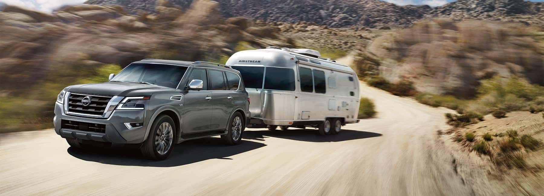 A 2021 Grey Nissan Armada hauling an Airstreem camper