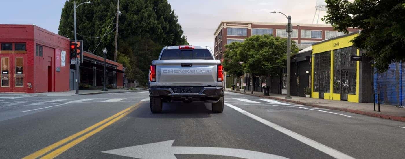 A silver 2024 Chevy Colorado is shown from the rear.