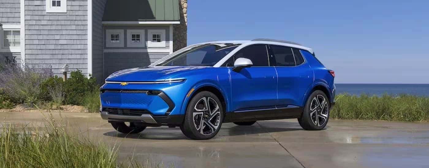 A blue 2024 Chevy Equinox EV 3LT is shown from the side.