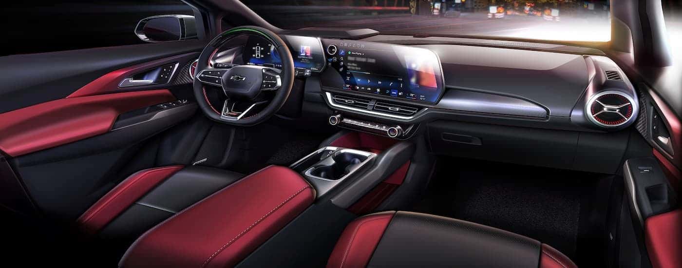 The black and red interior of a 2024 Chevy Equinox RS is shown from the passenger seat.