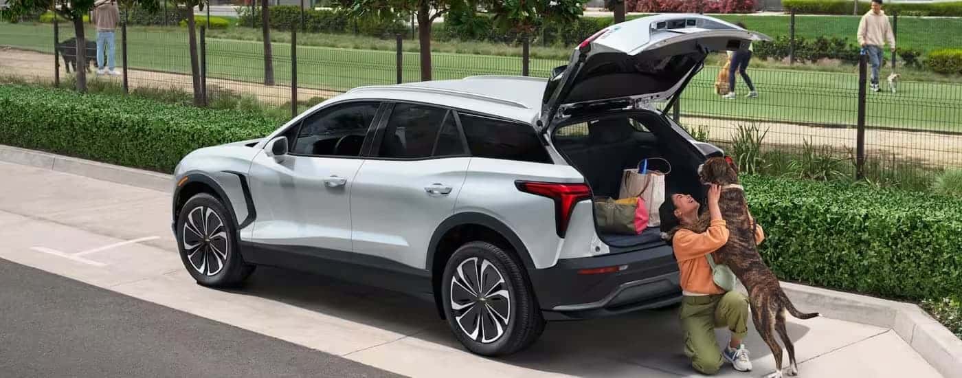 A white 2025 Chevy Blazer EV is parked near a park.