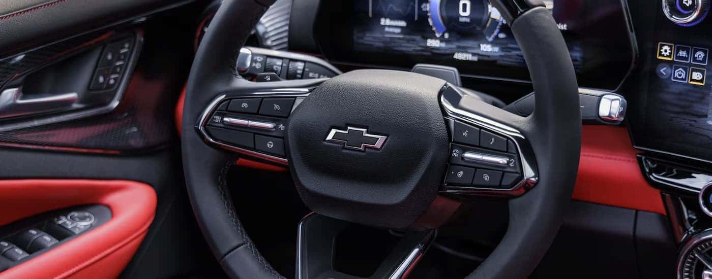A close up of the black and red steering wheel in a 2025 Chevy Blazer EV RS.
