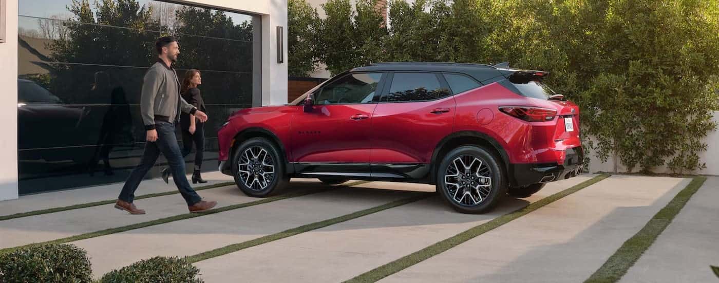 A red 2025 Chevy Blazer RS is shown parked on a driveway.