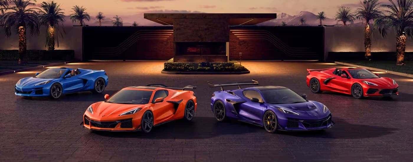 The 2025 Chevy Corvette lineup parked in front of a mansion.