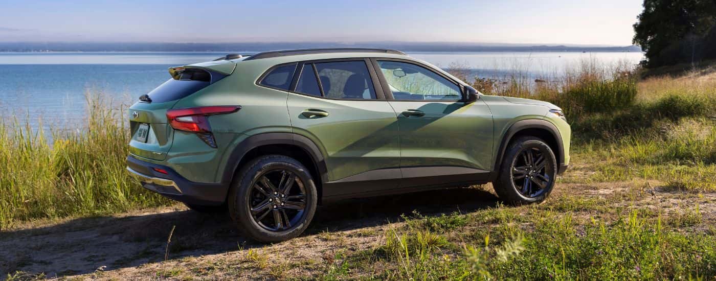 A green 2024 Chevy Trax ACTIV is shown from the side near a lake.