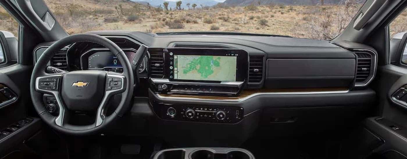 The black interior of a 2022 Chevy Silverado 1500 for sale is shown from above the center console.