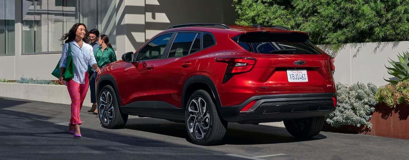 A red 2024 Chevy Trax RS is parked on the side of a street.