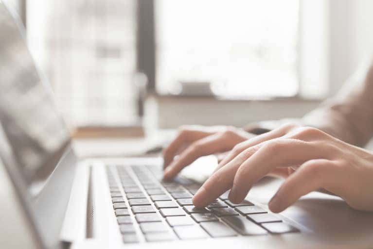 person typing on laptop