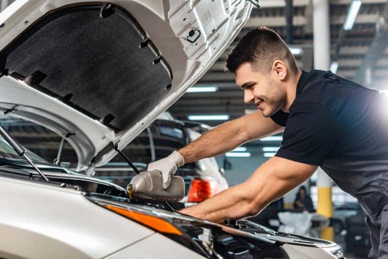 service specialist doing oil change