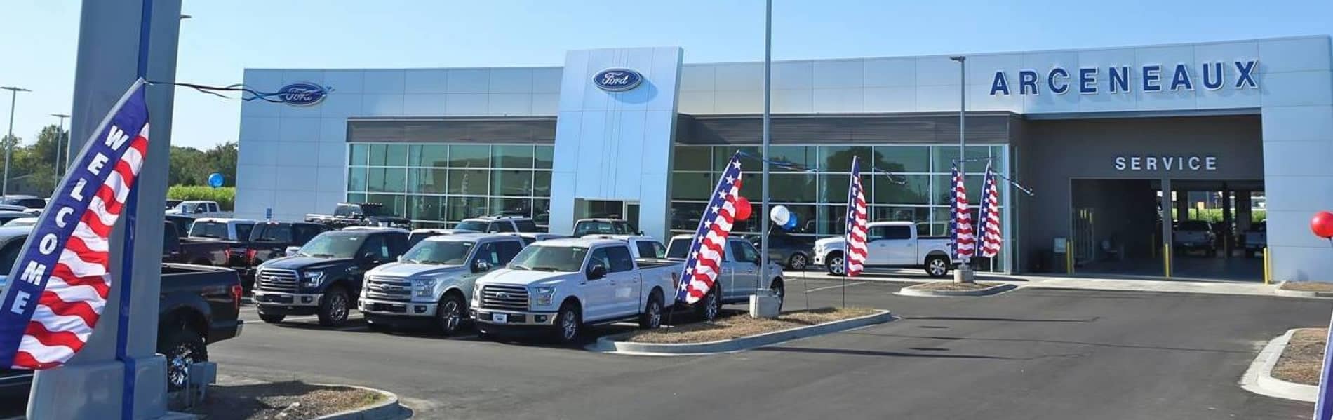 Arceneaux Ford outside of the dealership with Ford F-150 trucks on the lot