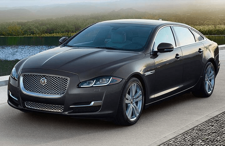side and front view of the 2018 Jaguar XJL parked by water