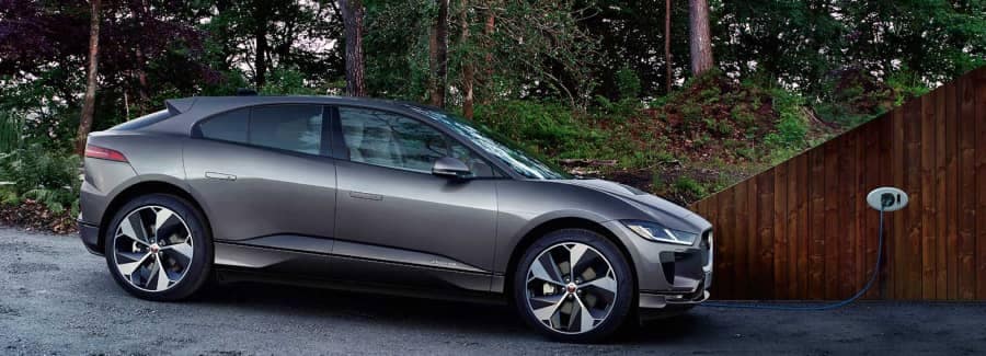 2022Jaguar_ipace-sideview-charging-in-driveway-grey