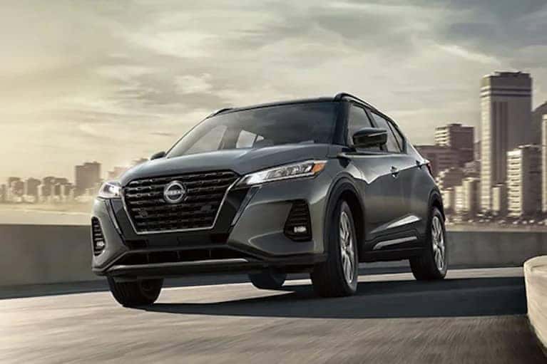 2022 Nissan Kicks on a highway with city in_