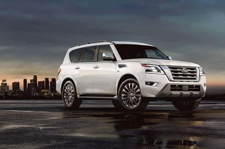 A 2021 White Nissan Armada parked at duck in front of a city skyline_mobile