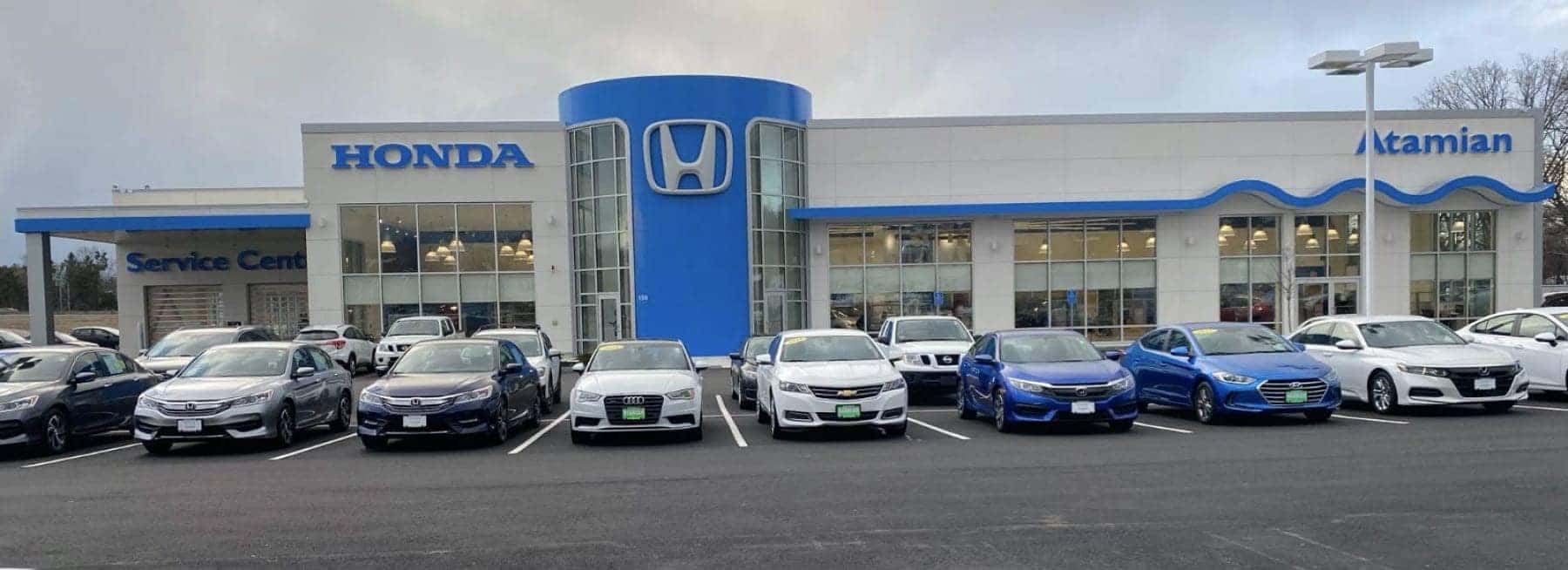 An exterior shot of a Honda dealership during the day