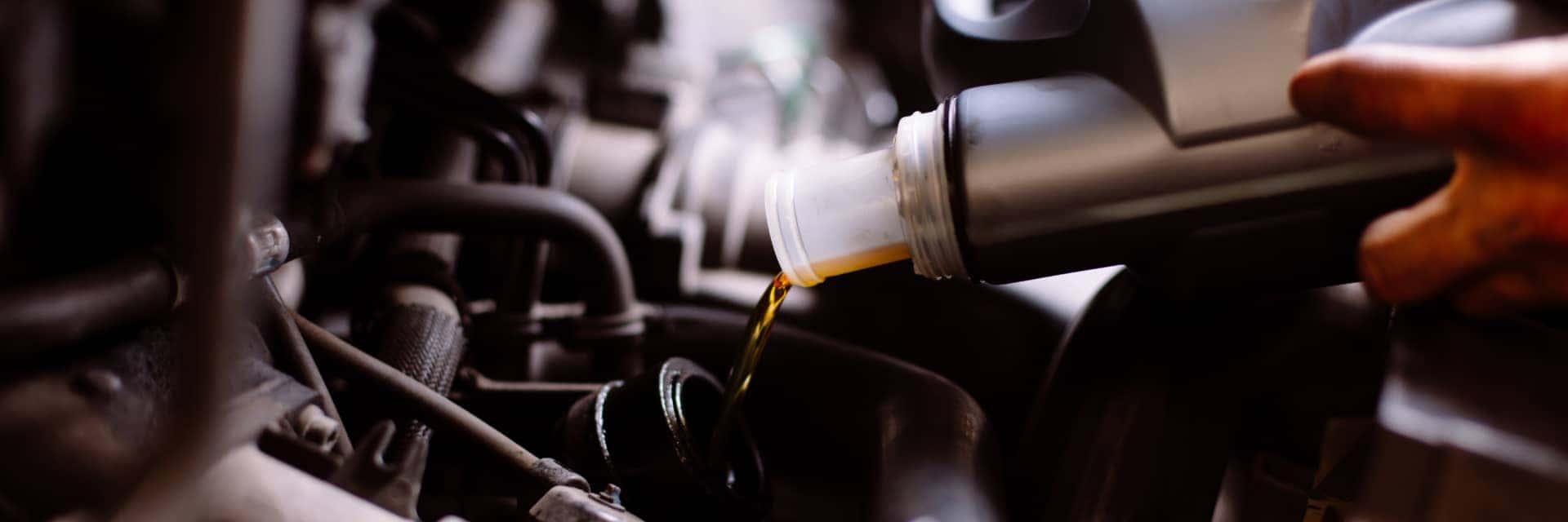 service specialist pouring oil