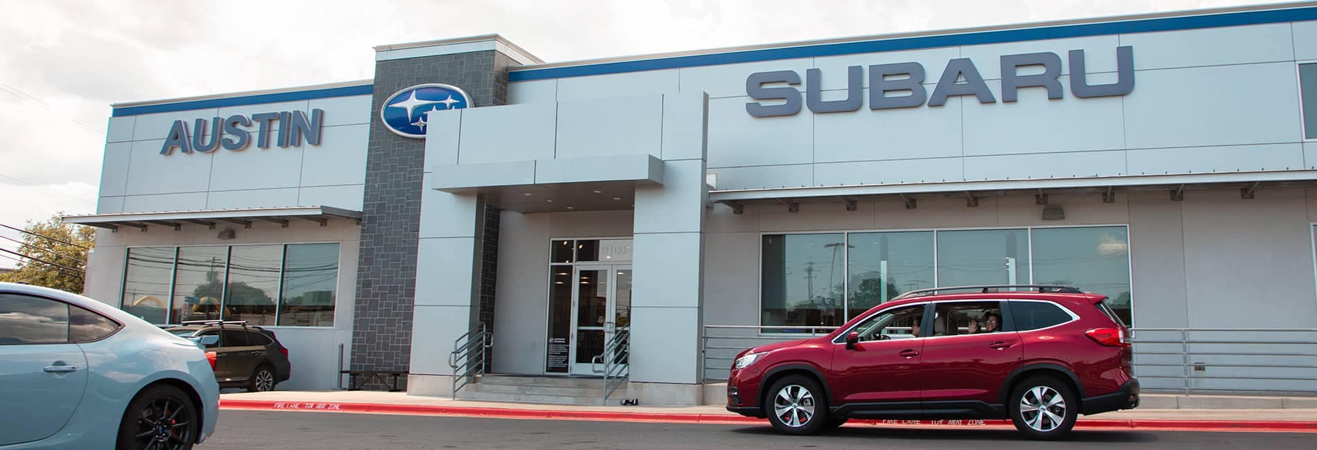 Austin Subaru with a view of outside the dealership and a bunch of Subaru models