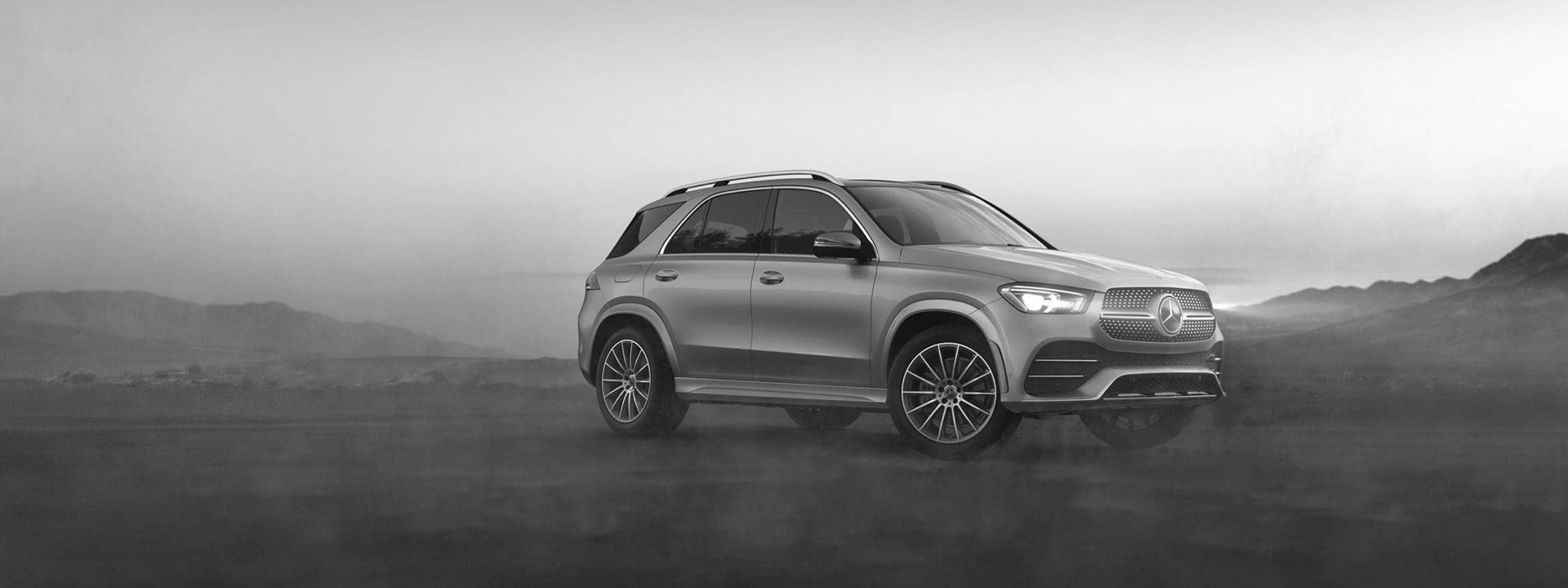 Grayscale 2020 Mercedes GLE parked in foggy plains