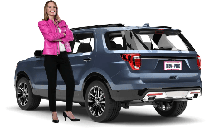 Image of a woman in pink jacket standing next to SUV