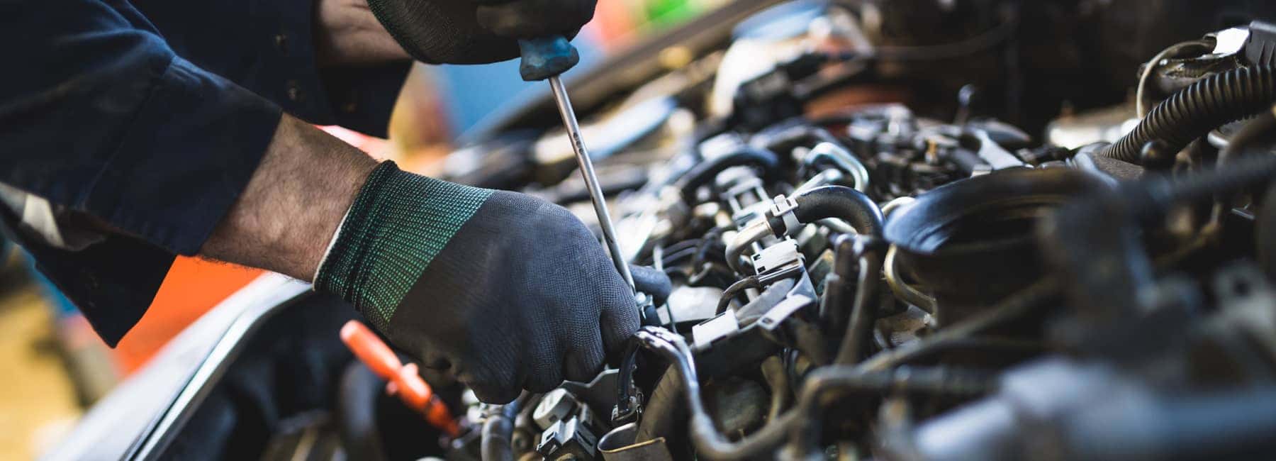 Vehicle Mechanic Working On An Engine