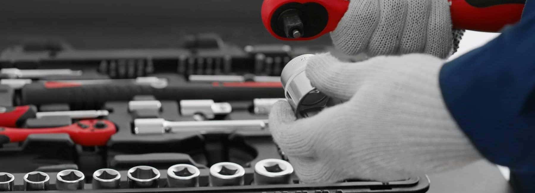 Gloved Mechanic Holding Tools