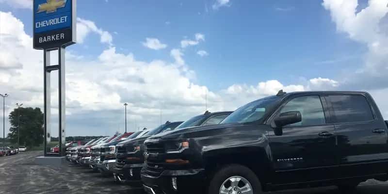 Barker-Chevrolet-dealership-lot-with-a-tall-sign-of-their-name