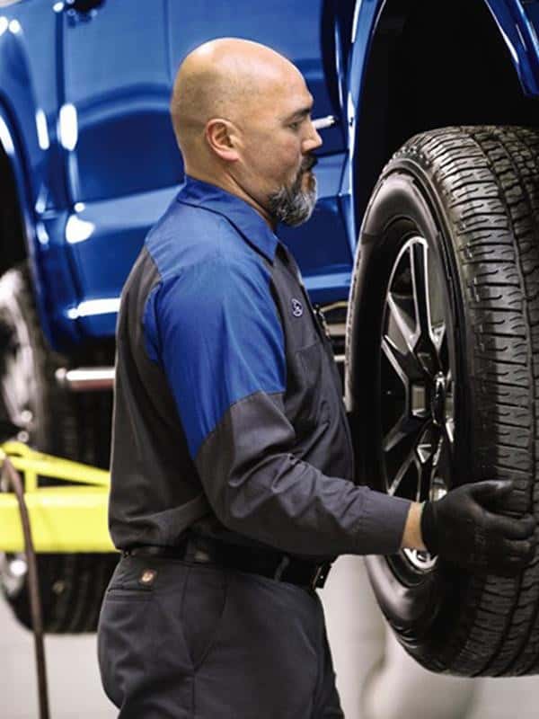 Technician installing wheel
