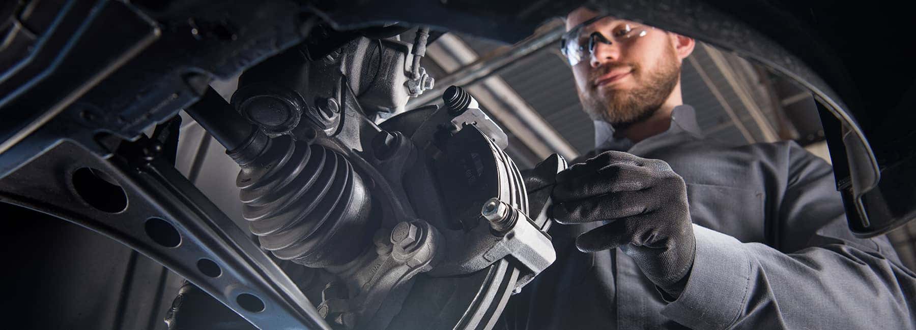 Auto service technician working on a vehicle