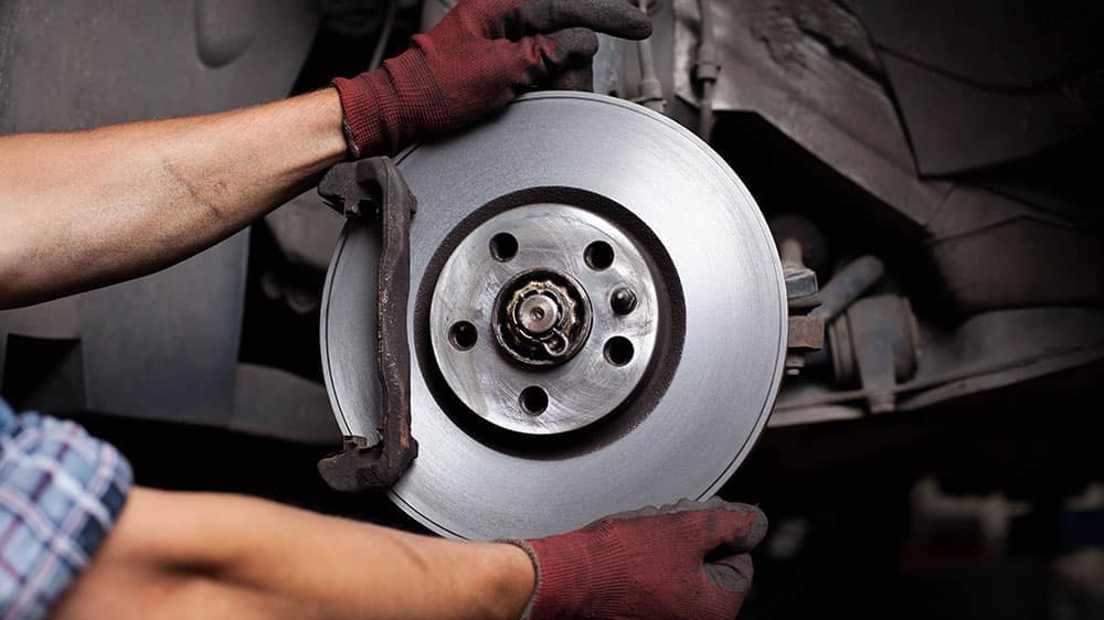 Car-mechanic-Repairing-brakes-on-car_