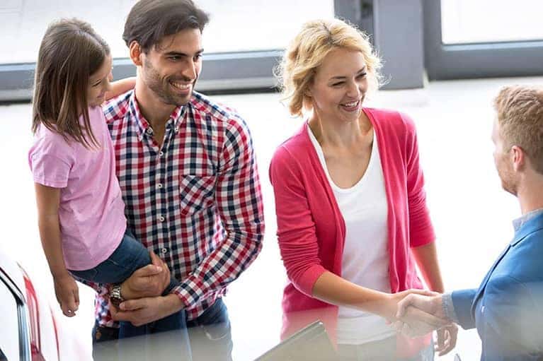 Dealership helping out customers on picking their newest car