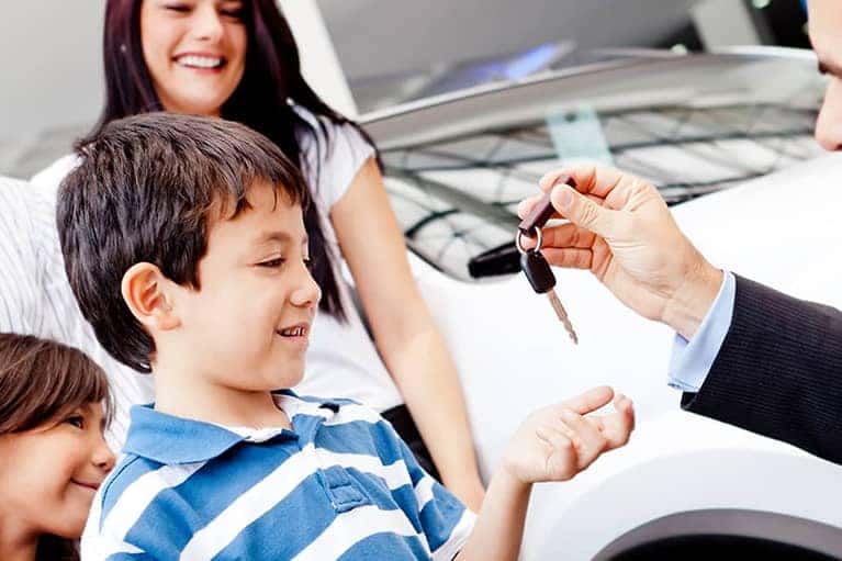 Family renting a Toyota vehicle from a dealership