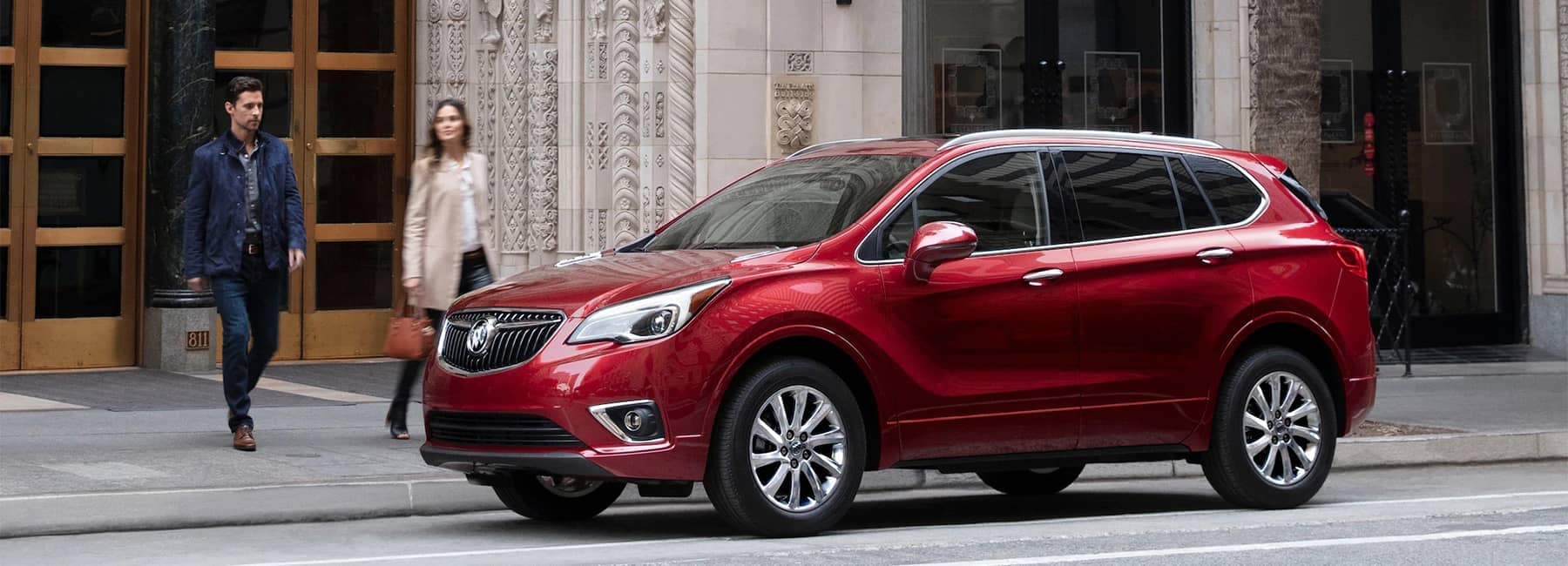 2020-Buick-Envision-Compact-SUV-with-Man-and-Woman-Walking