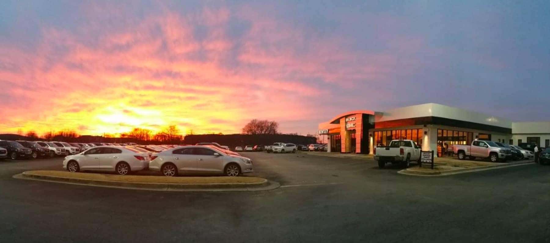 exterior view of dealership with sun setting in the distance