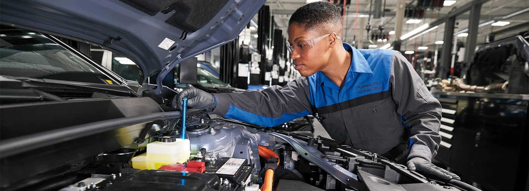 Subaru Service Technician inspecting an engine