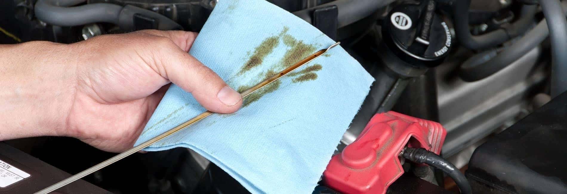 Technician checking the oil