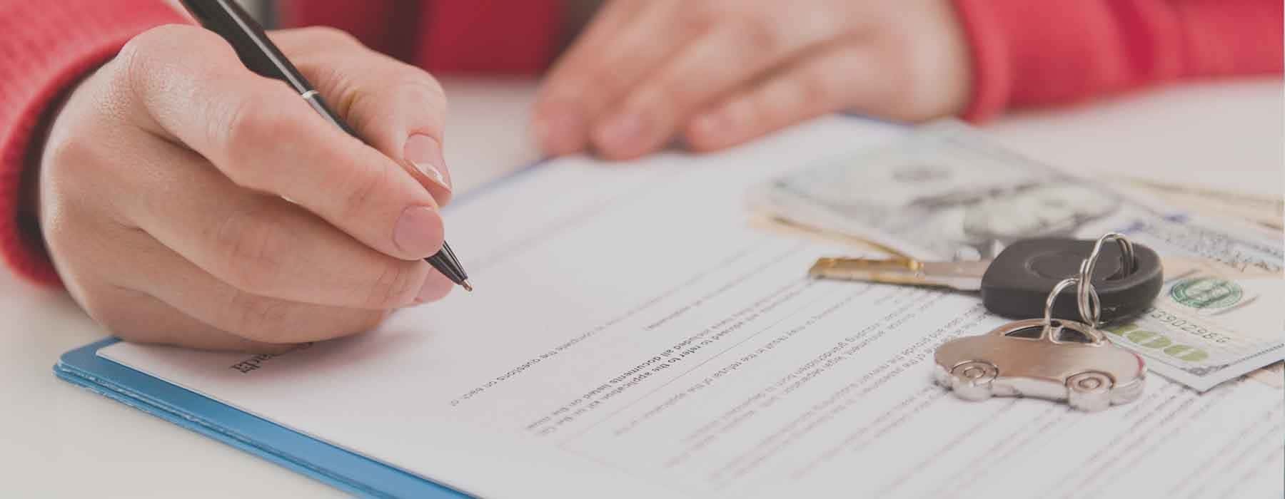 Woman signing finance documents