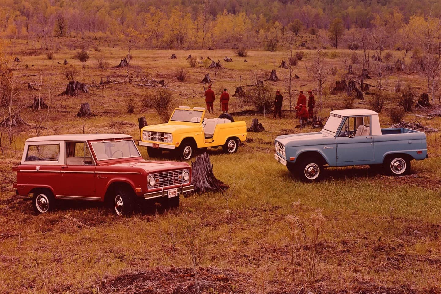 1969 Ford Bronco Sport Wagon in Royal Maroon with Wimbledon White roof, 1969 Ford Bronco roadster in Empire Yellow, 1969 Ford Bronco pickup in Skyview Blue with Wimbledon White roof.
