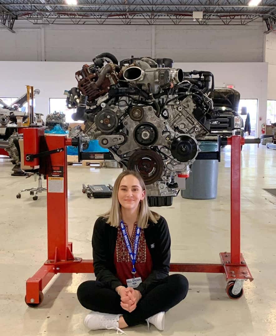 Bill Brown employee in front of car engine