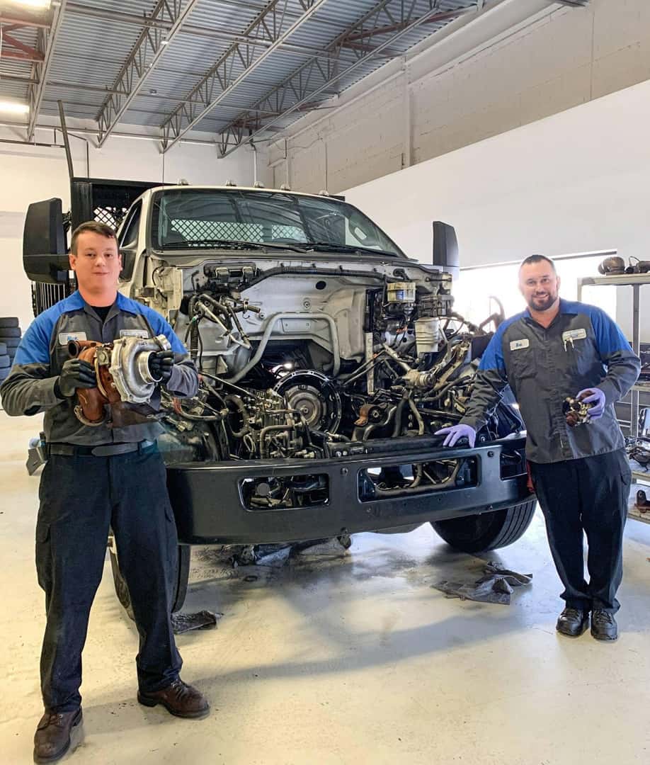 Bill Brown Service Employees working on engine