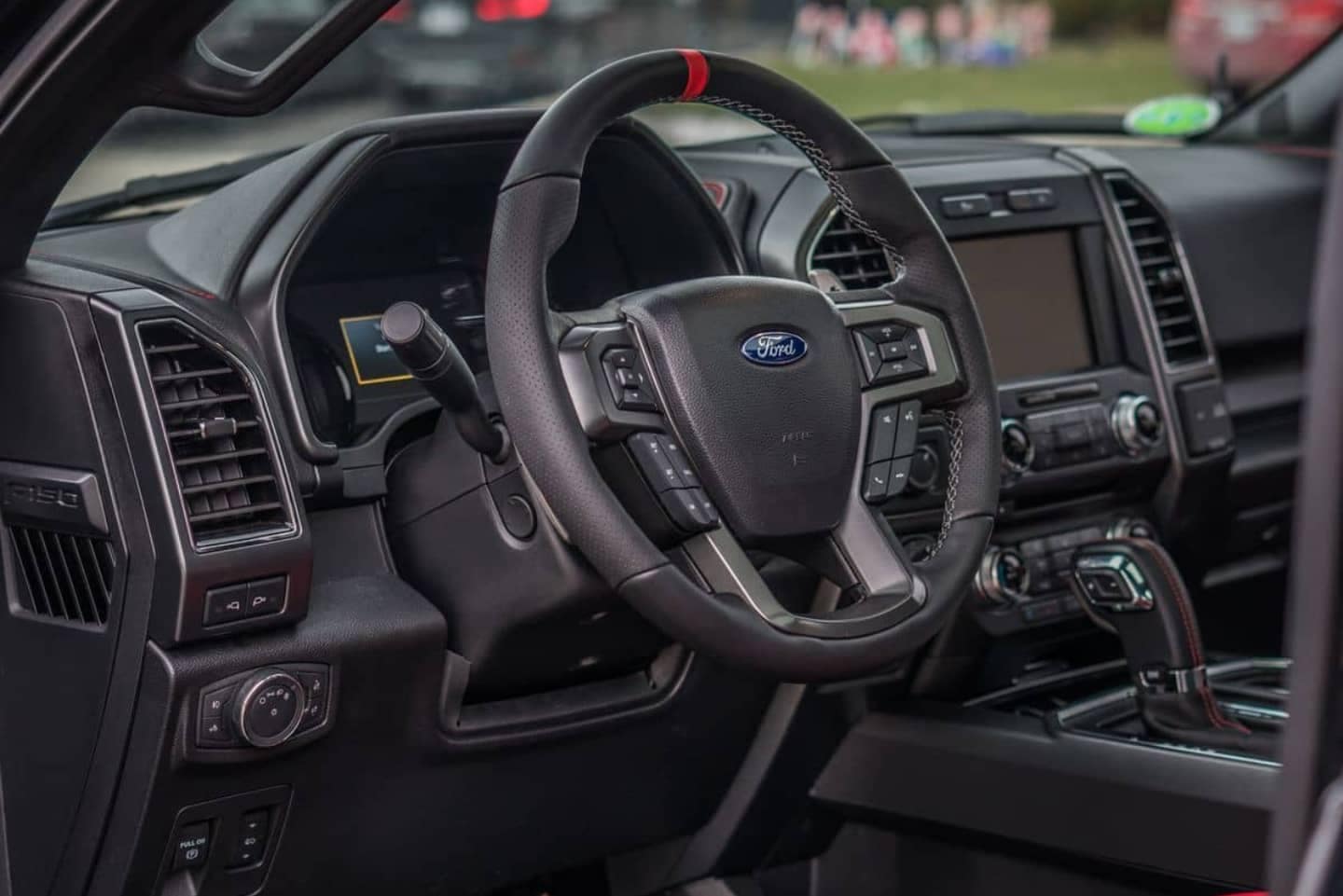 Used Ford F-150 Interior in black leather with red accents.