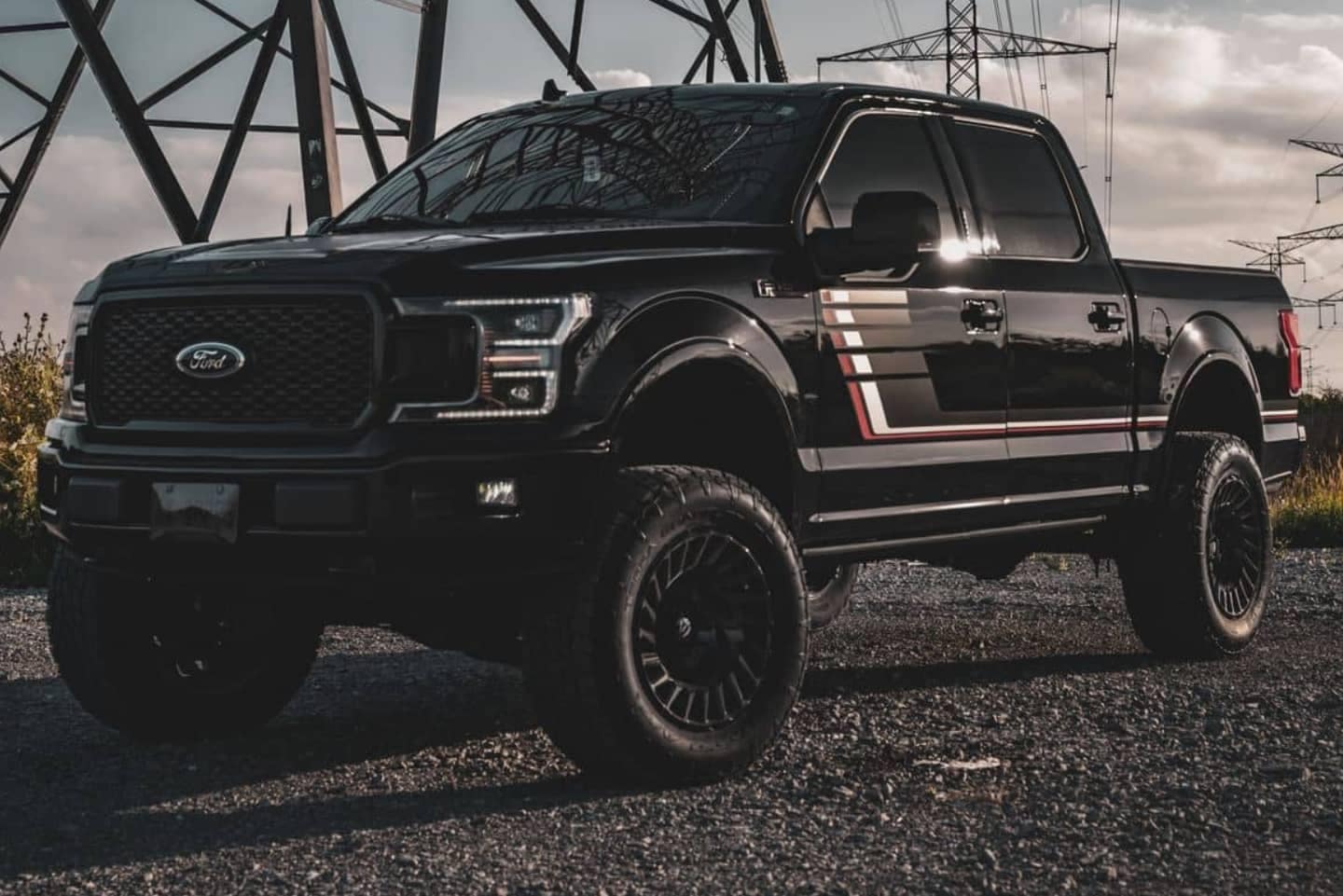 Used Ford F150 Lariat Special Edition in black on the pavement.