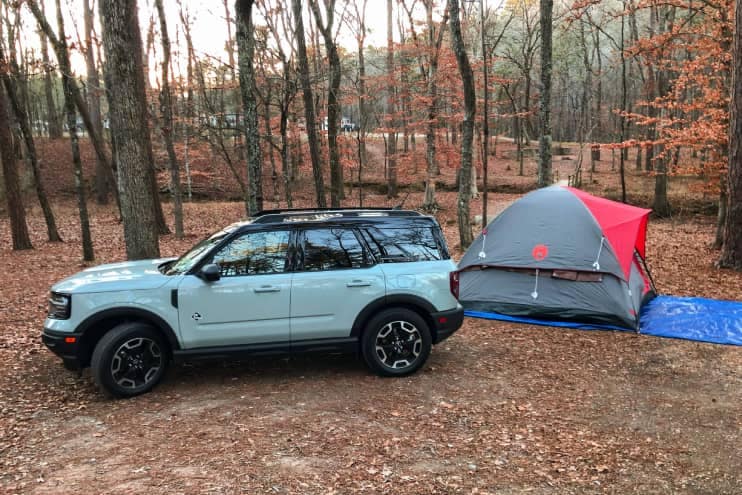 All-New Bronco Sport Outer Banks in a campground with a tent pitched nearby.