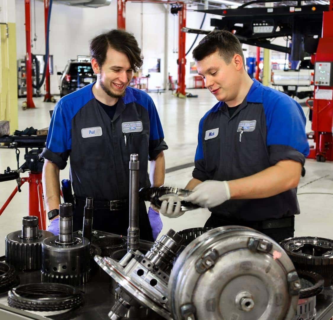 Two mechanics looking at parts